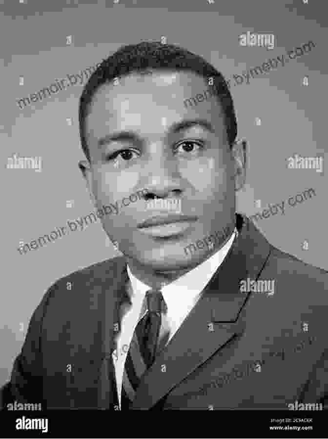 A Black And White Photograph Of Joseph Mitchell, A Man With A Serious Expression, Wearing A Suit And Tie, Sitting At A Desk With A Typewriter In Front Of Him. Man In Profile: Joseph Mitchell Of The New Yorker