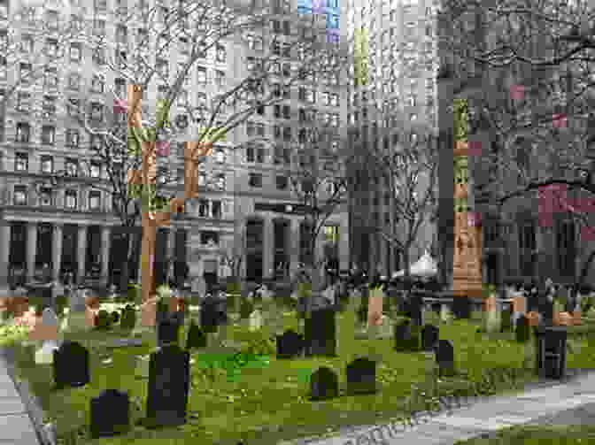 A Serene View Of Trinity Churchyard In Lower Manhattan, With Tombstones And The Historic Trinity Church In The Background. Stories In Stone: New York: A Field Guide To New York City Area Cemeteries Their Residents