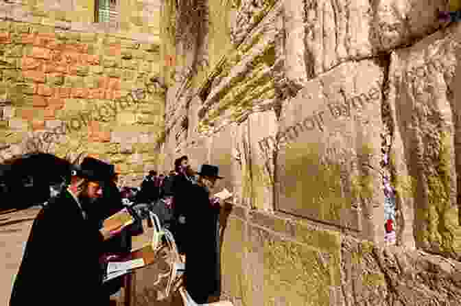 Group Of Pilgrims Praying At The Western Wall In Jerusalem. Experiencing The Land Of The Book: A Life Changing Journey Through Israel